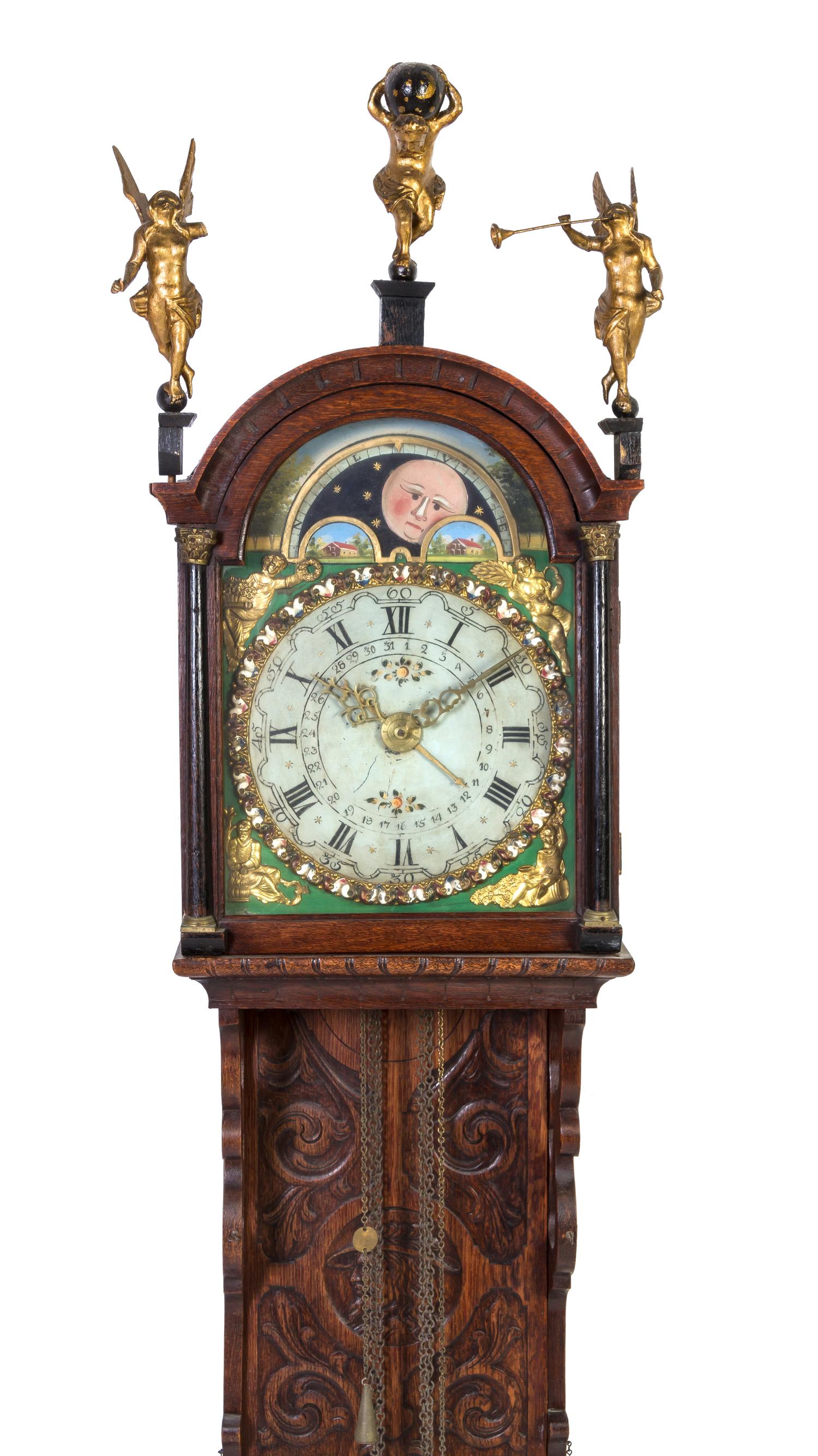 A Dutch Carved Oak Bracket Clock, Height 60 inches.