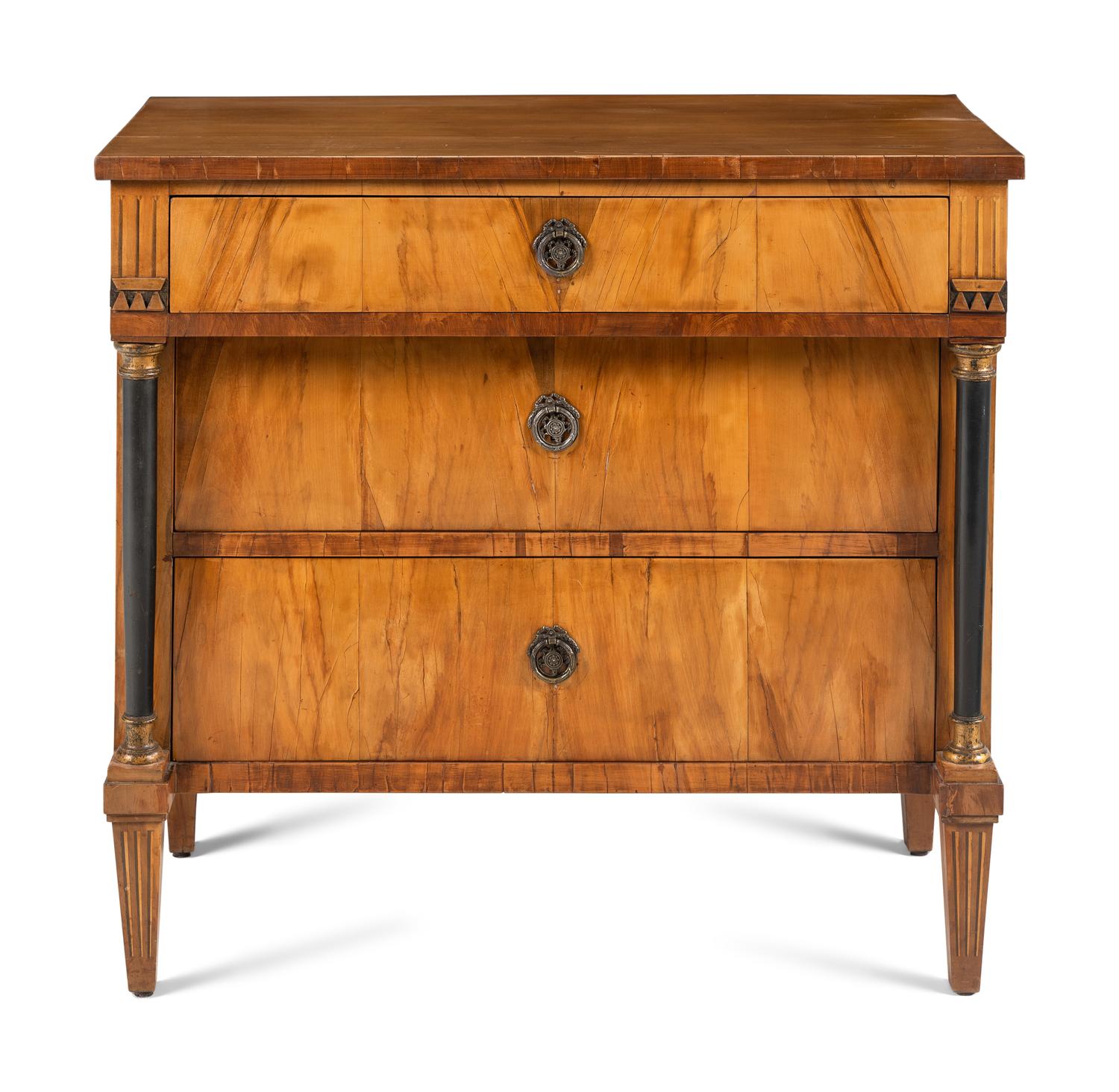 A Biedermeier Walnut and Parcel Ebonized Commode