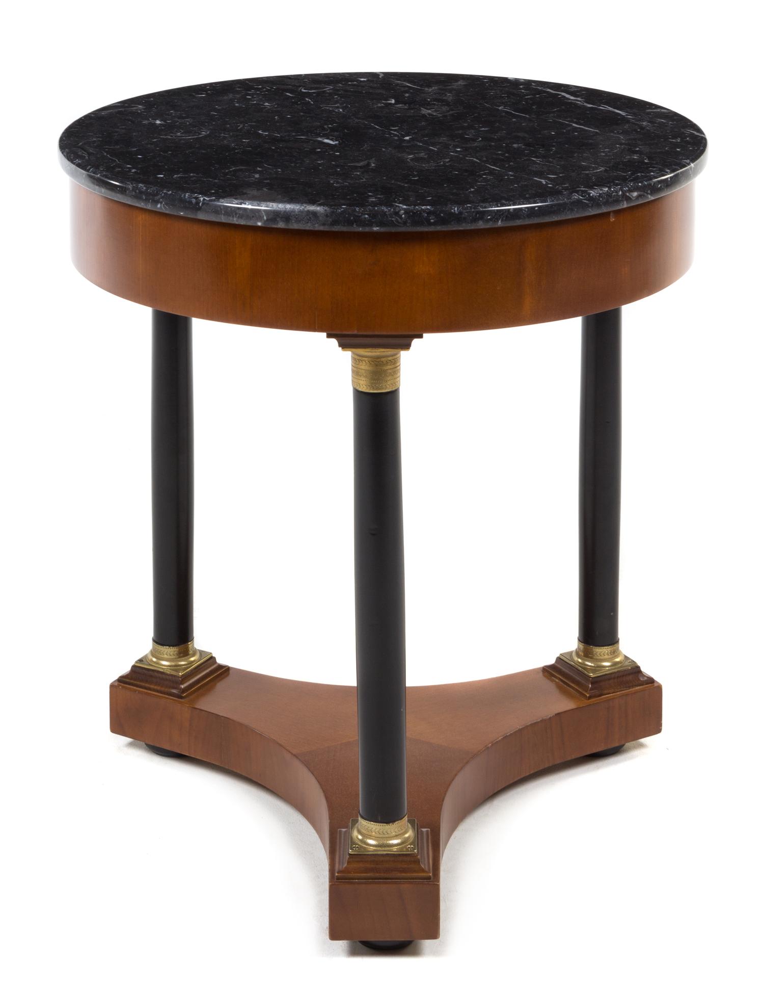 An Italian Empire Style Gilt Metal Mounted and Parcel Ebonized Table Height 25 x diameter of top 23 inches. — 20TH CENTURY