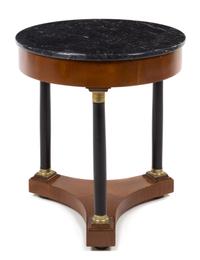 An Italian Empire Style Gilt Metal Mounted and Parcel Ebonized Table Height 25 x diameter of top 23 inches. — 20TH CENTURY