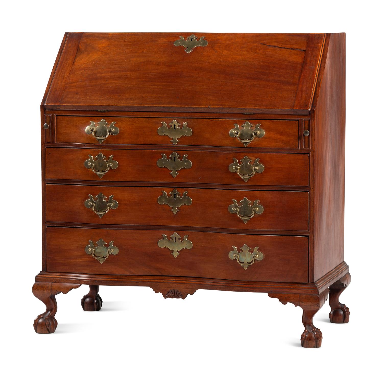 A Chippendale Carved and Figured Mahogany Reverse-Serpentine Claw-and-Ball Foot Slant-Front Desk