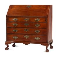 A Chippendale Carved and Figured Mahogany Reverse-Serpentine Claw-and-Ball Foot Slant-Front Desk