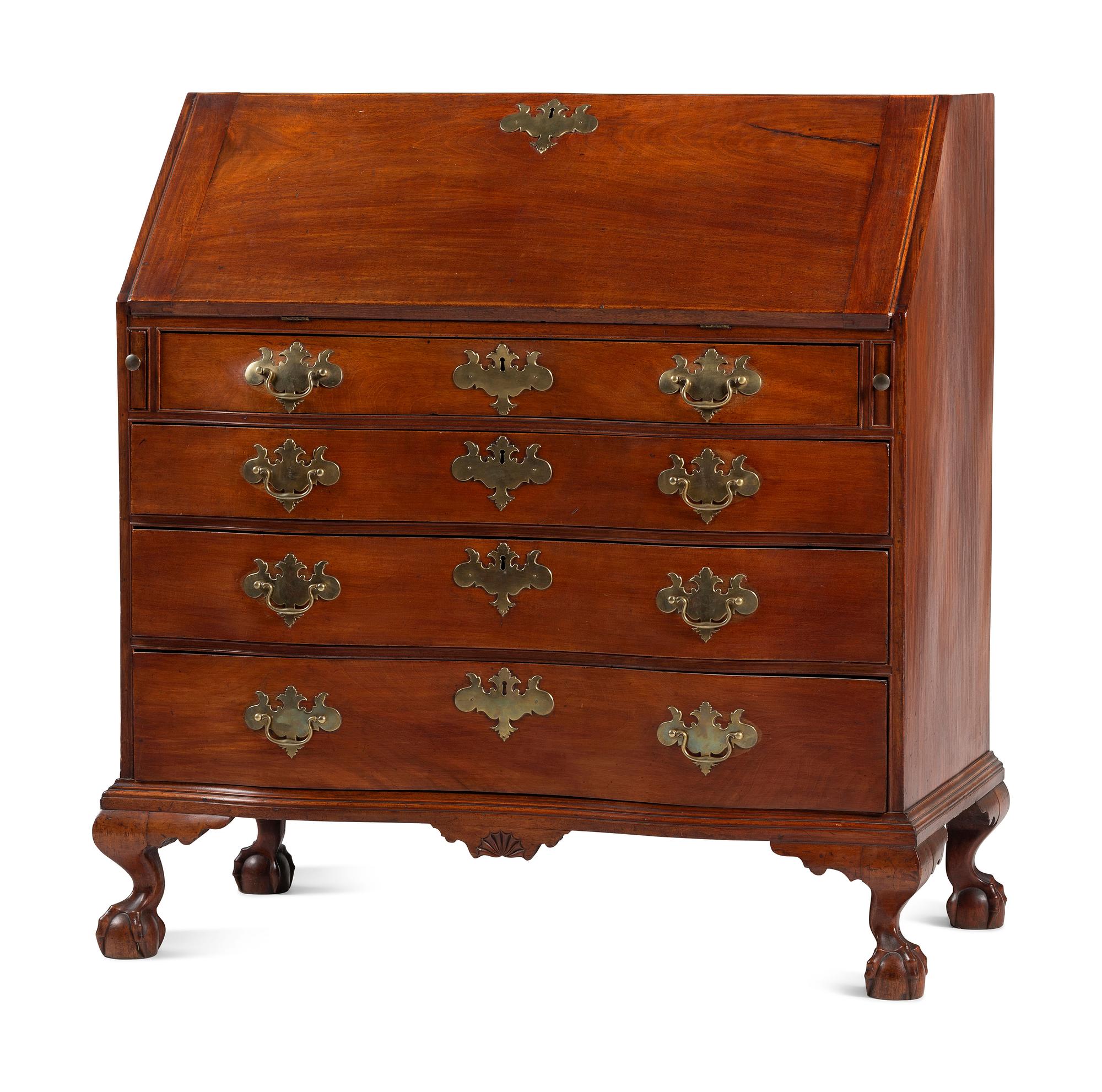 A Chippendale Carved and Figured Mahogany Reverse-Serpentine Claw-and-Ball Foot Slant-Front Desk