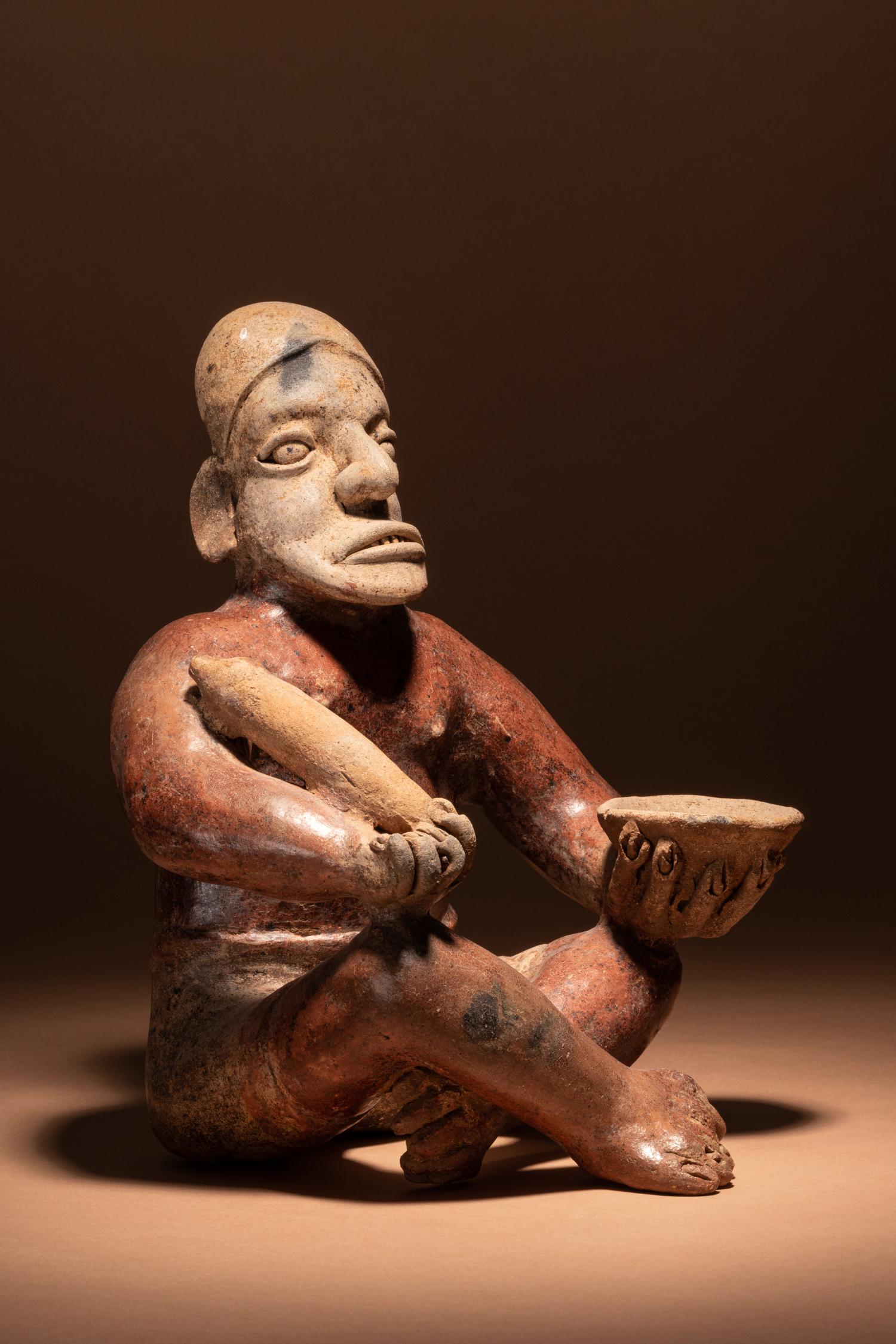 A Jalisco Seated Figure with Offerings