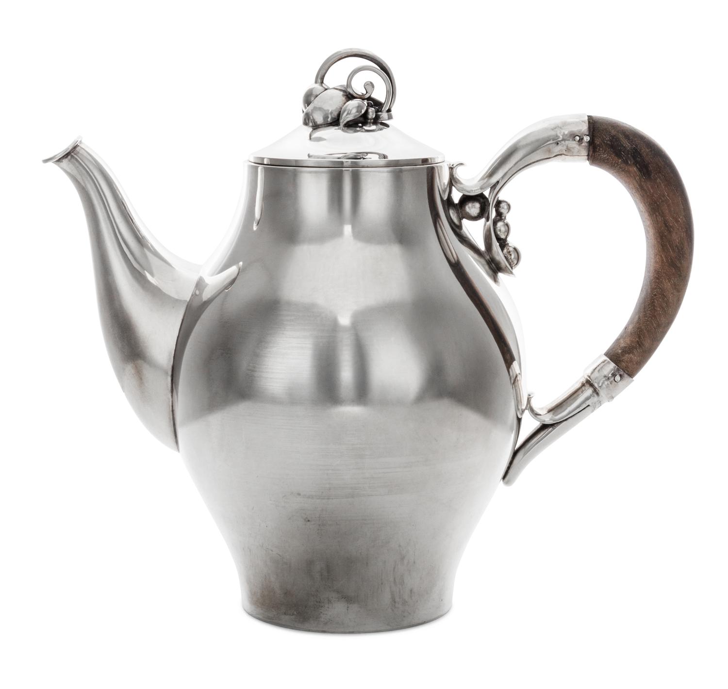 A Danish Silver Teapot, Holger Rasmussen, Copenhagen, 20th Century, of ovoid form having a foliate finial and mount, with wood handle.