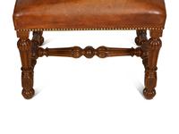 A Pair of Carved Walnut Regence Style Leather Upholstered Stools