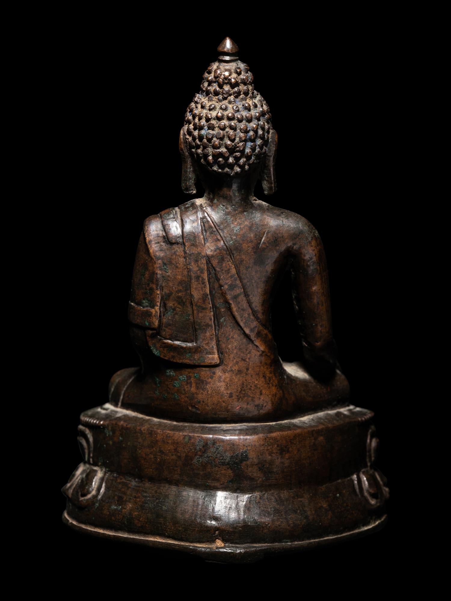 A Tibetan Bronze Figure of Seated Buddha Akshobhya