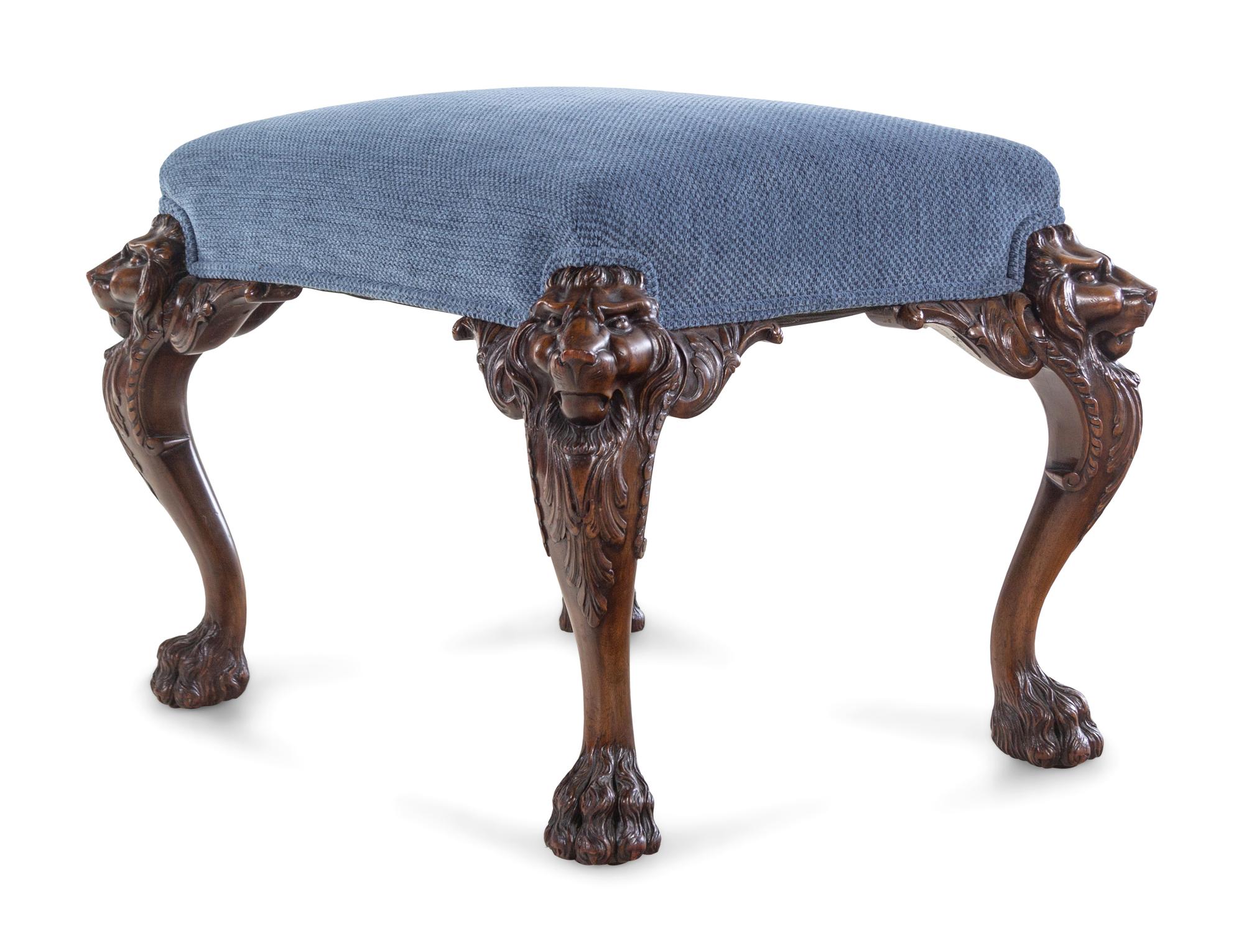 An Edwardian Carved Mahogany Foot Stool