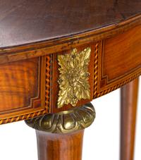 A Louis XVI Style Gilt Metal Mounted Walnut and Marquetry Extension Dining Table