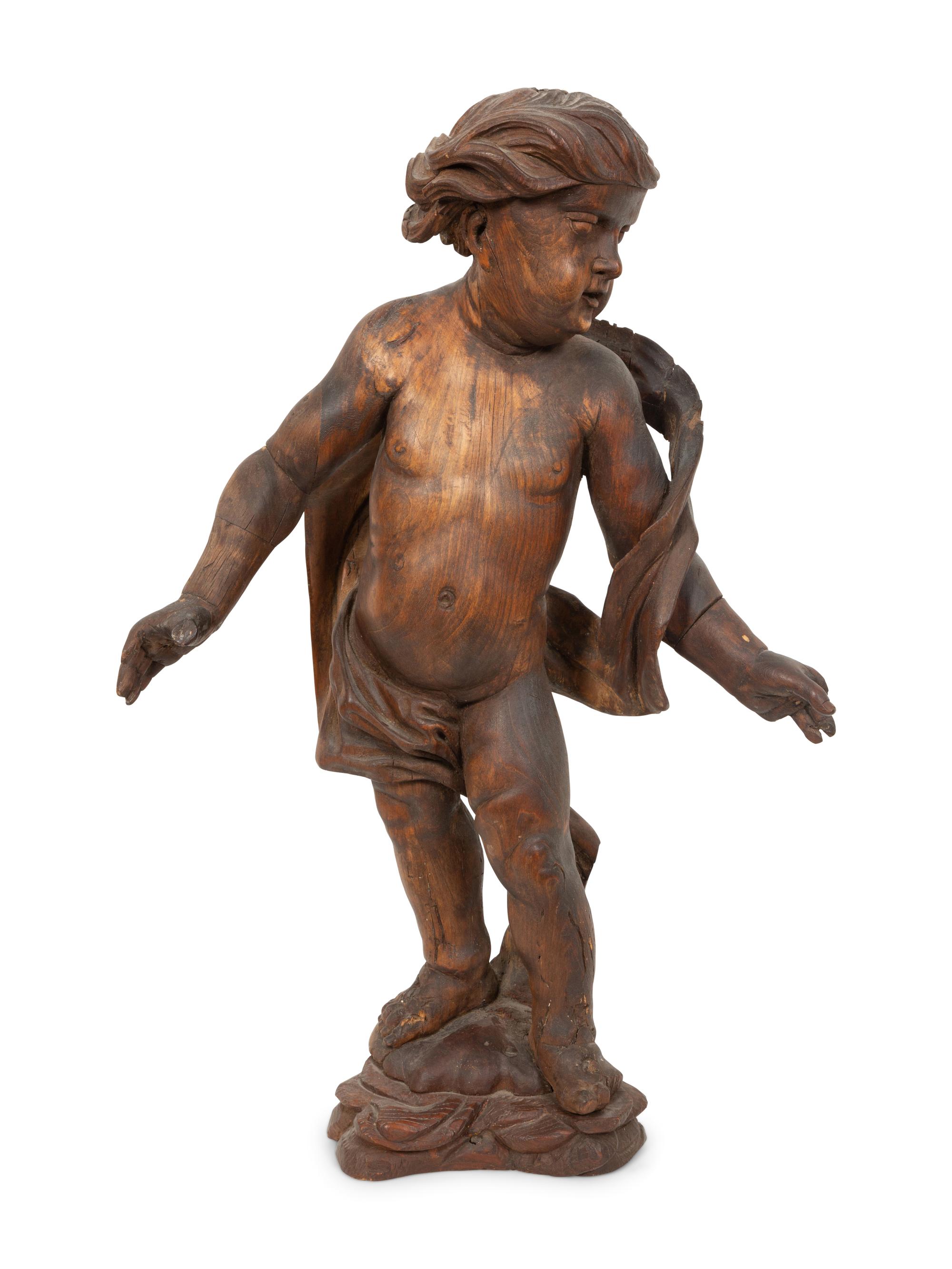 An Italian Carved Walnut Figure of Putto