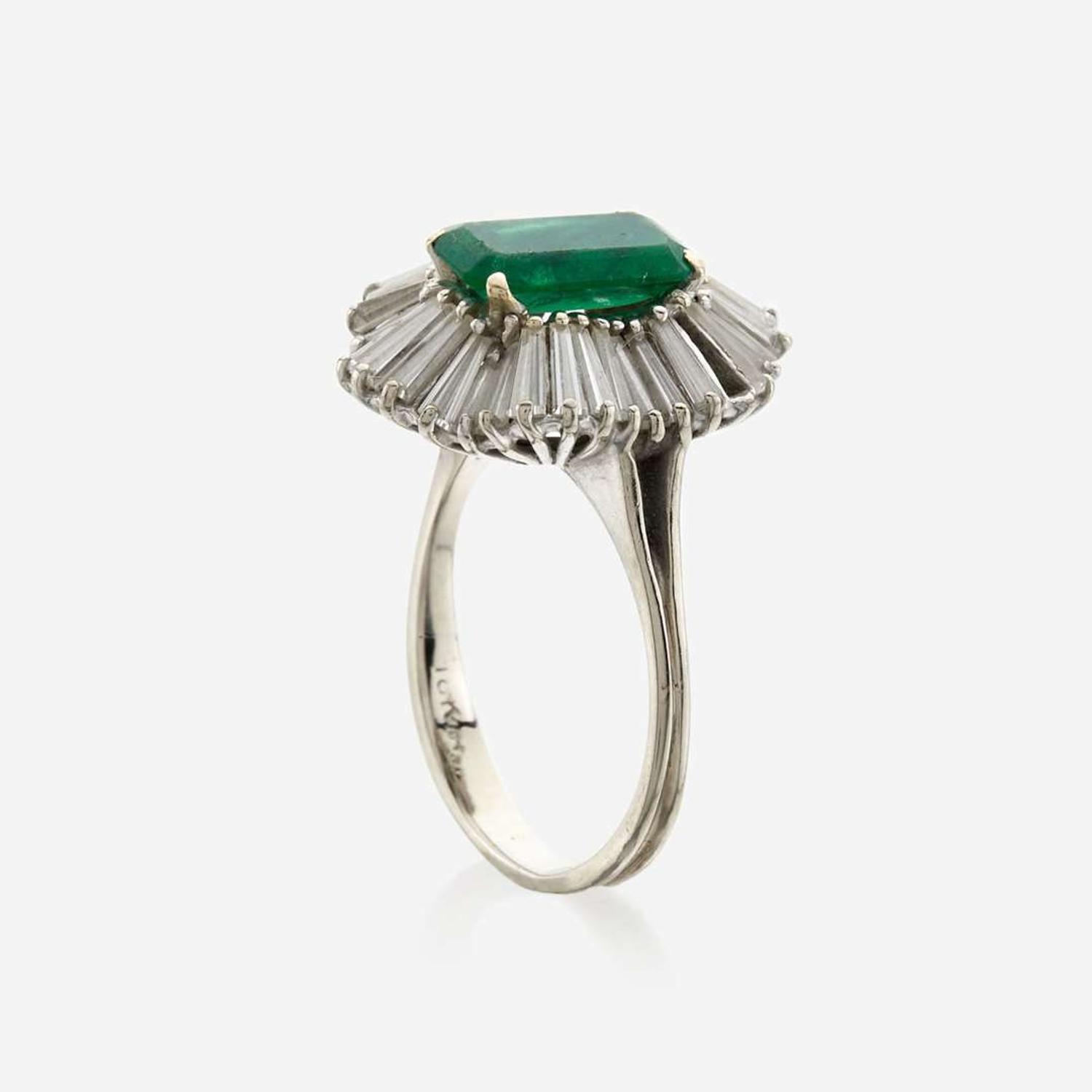 An emerald, diamond, and white gold ring