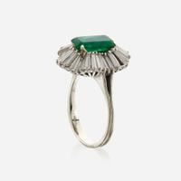 An emerald, diamond, and white gold ring