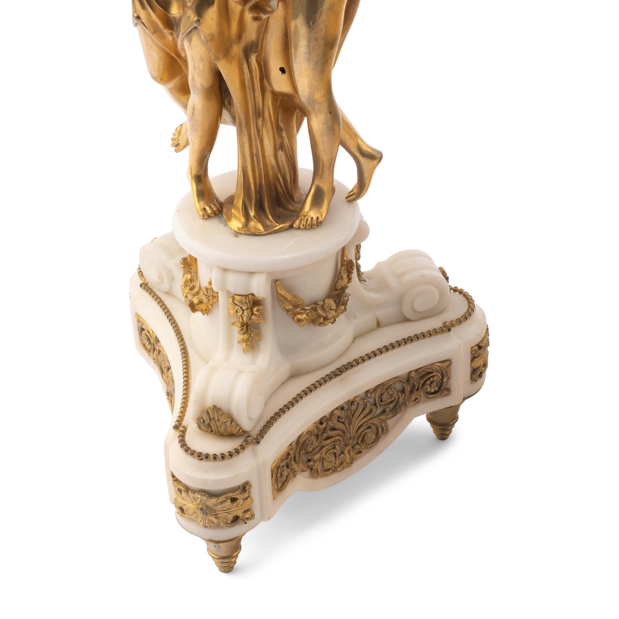 A Louis XVI Style Gilt-Bronze and White Marble Annular Clock Garniture