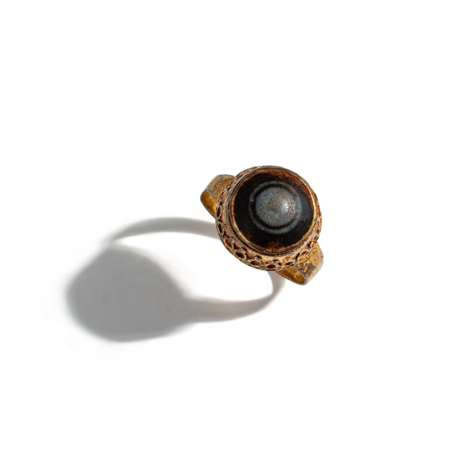 A Near Eastern Banded Agate Cabochon — Set in a gold ring