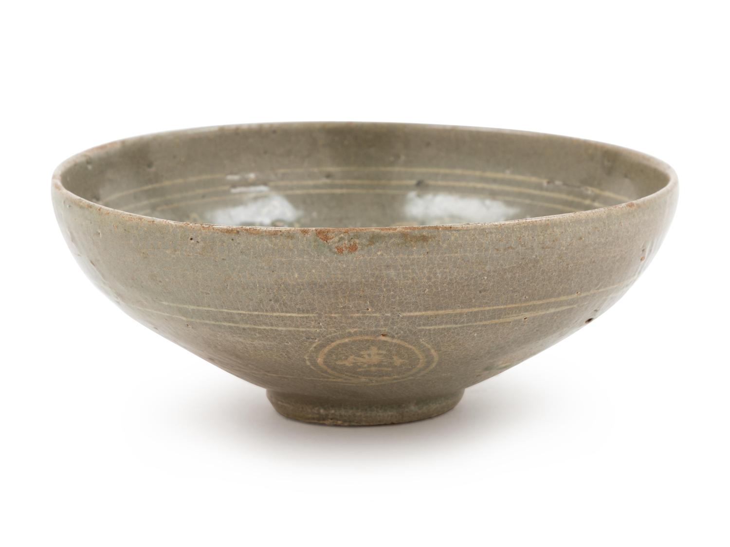 A Slip Decorated Celadon Glazed Ceramic Bowl