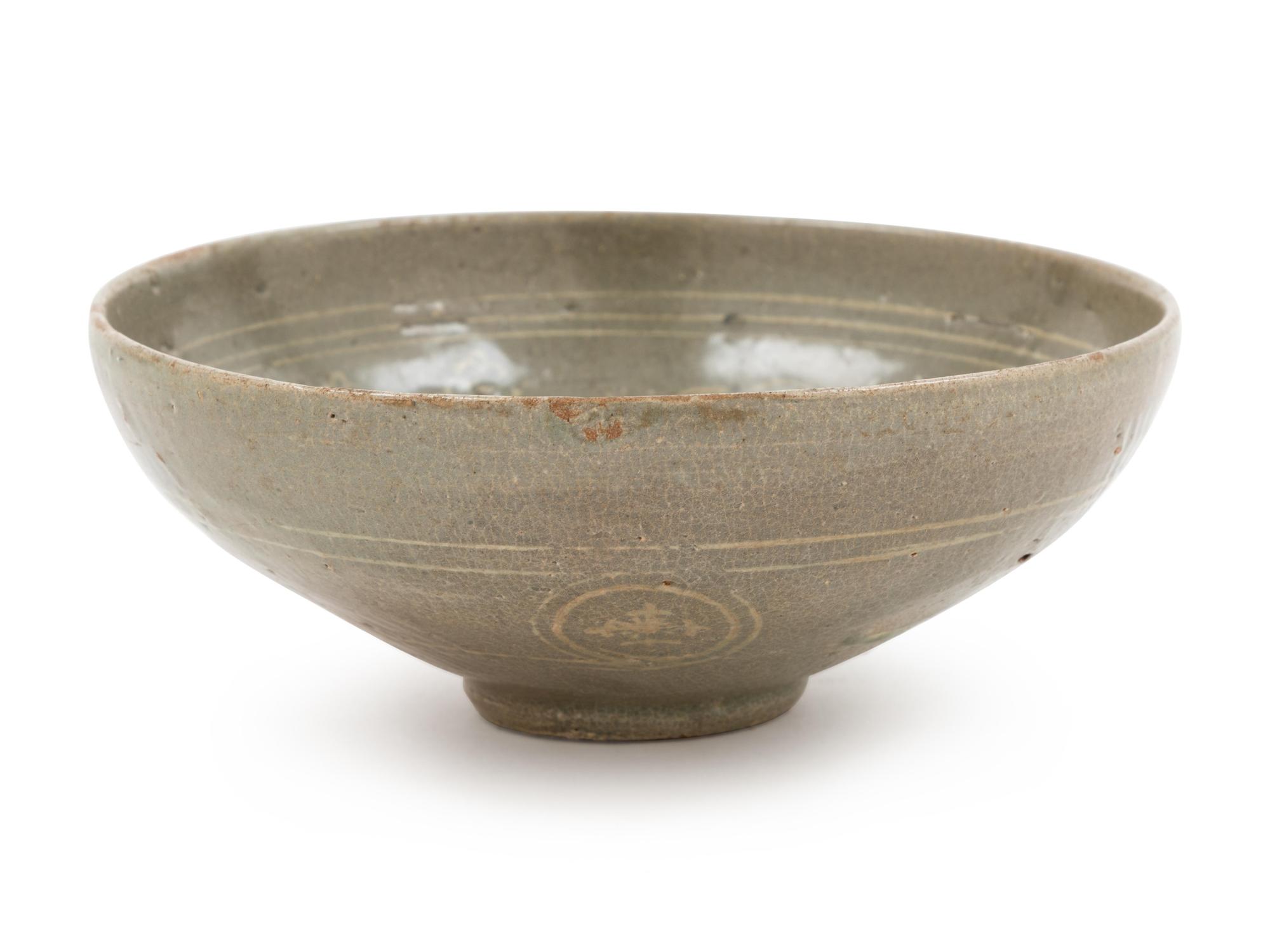 A Slip Decorated Celadon Glazed Ceramic Bowl