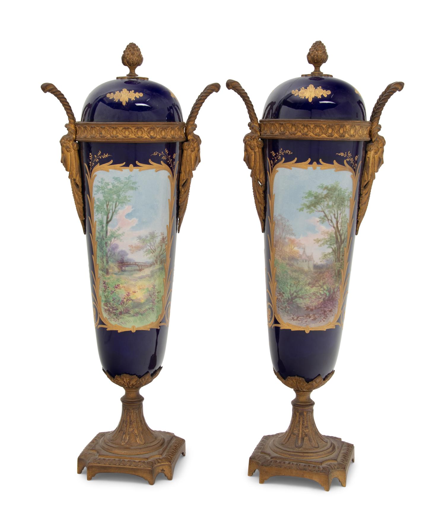 A Pair of Sèvres Style Gilt Bronze Mounted Porcelain Urns