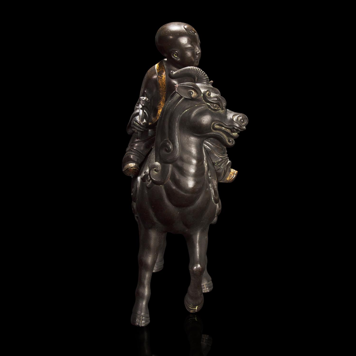 A Chinese Patinated and Parcel-gilt Bronze 'Qilin and Boy' Censer, 17th/18th Century 清早期 銅局部鎏金麒麟童子香薰