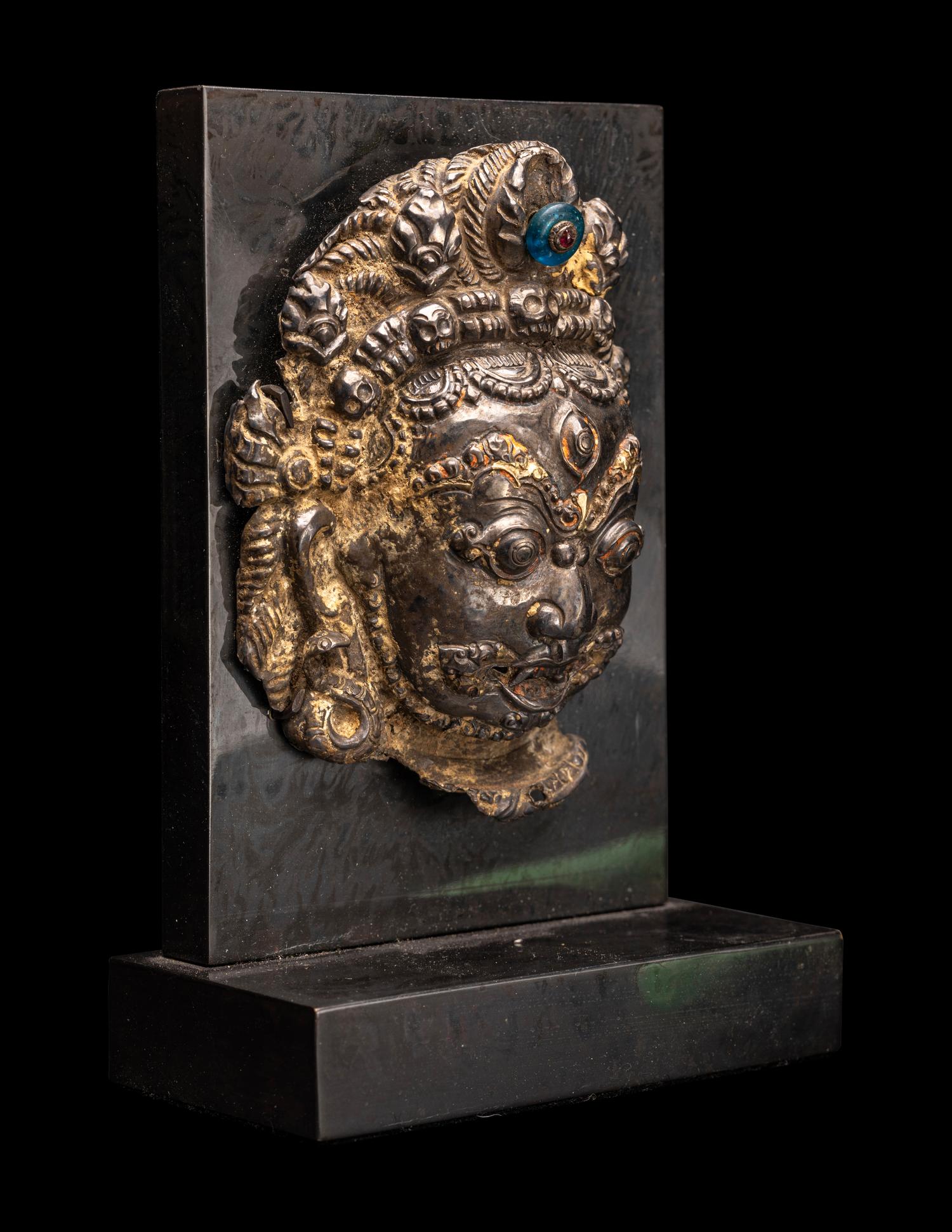 A Nepalese Silvered Metal Repouss é Mask of Bhairava