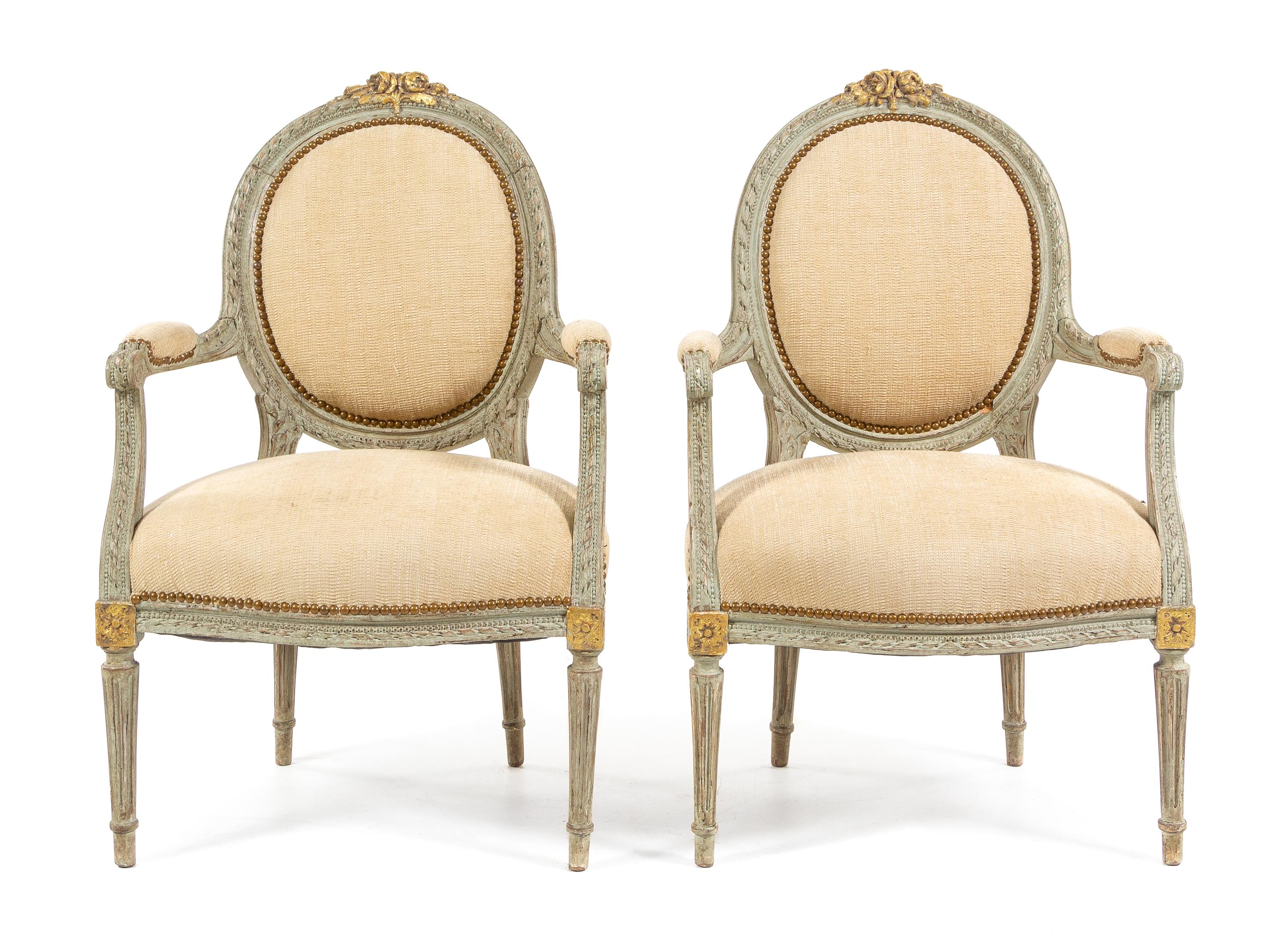 A Pair of Louis XVI Style Painted and Parcel Gilt Fauteuils Height 37 inches. — MID-19TH CENTURY