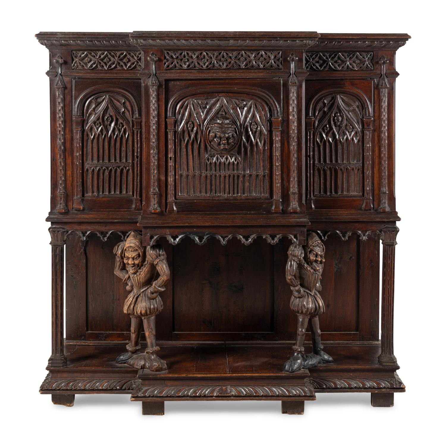 A Gothic Revival Carved Oak Court Cupboard