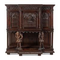 A Gothic Revival Carved Oak Court Cupboard
