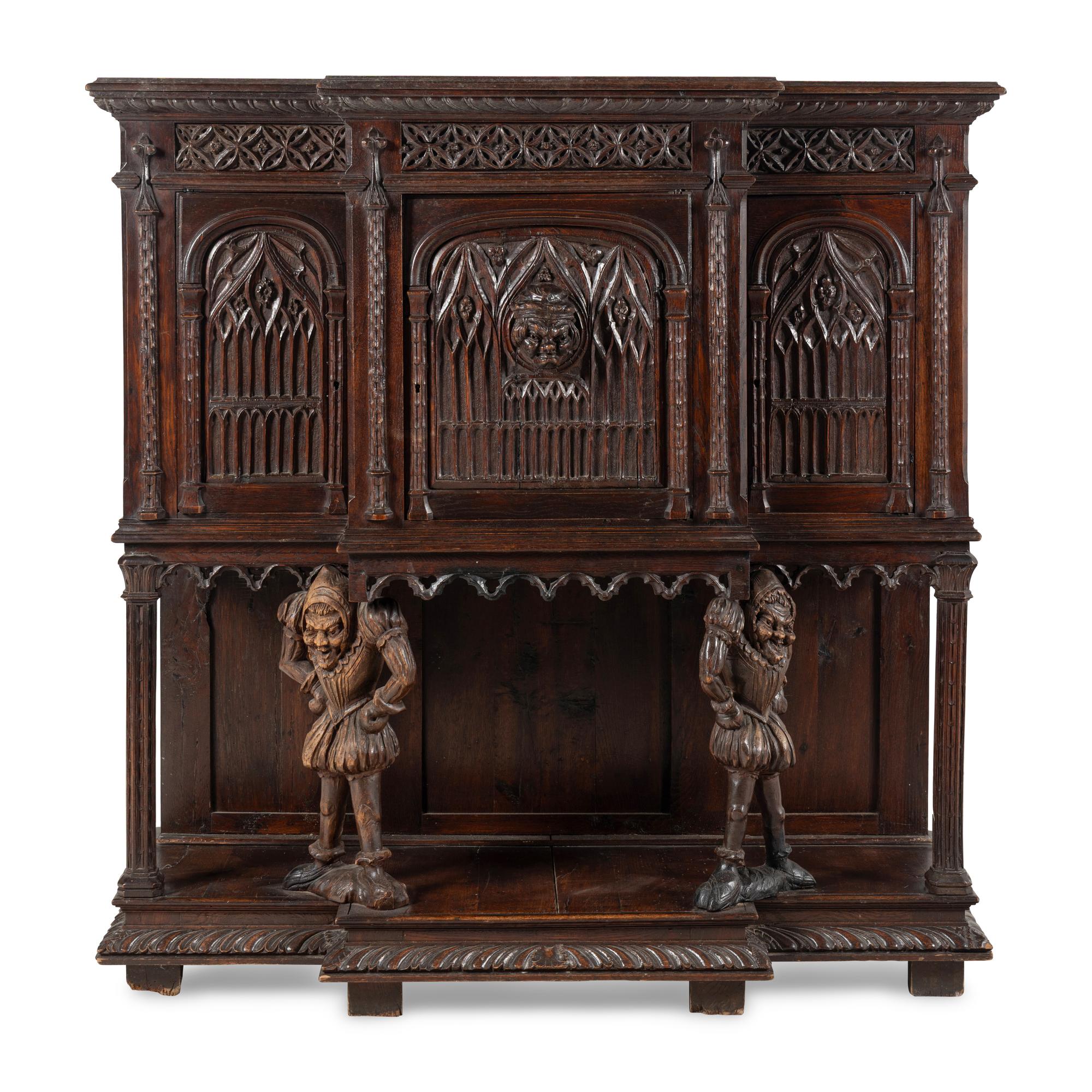 A Gothic Revival Carved Oak Court Cupboard