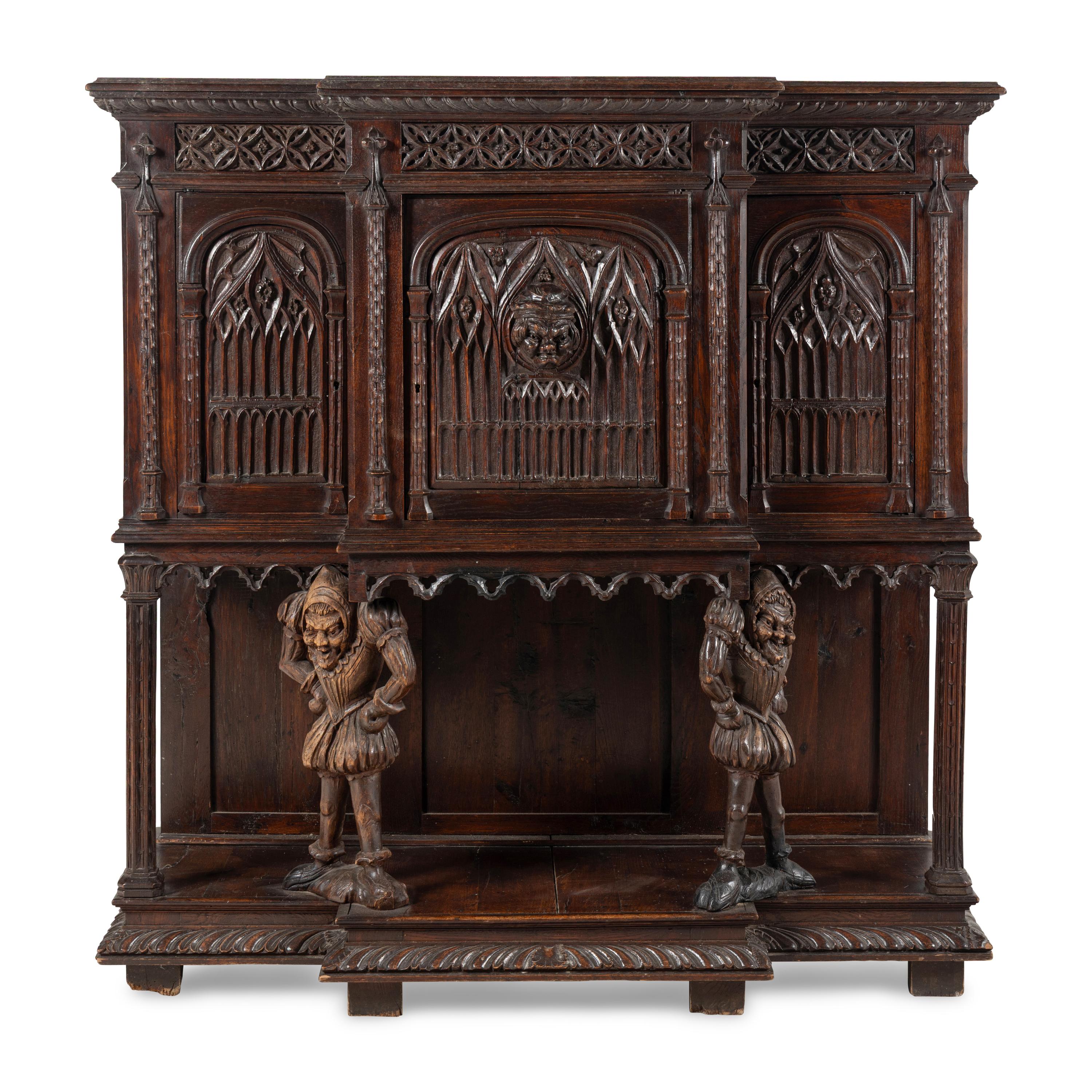 A Gothic Revival Carved Oak Court Cupboard