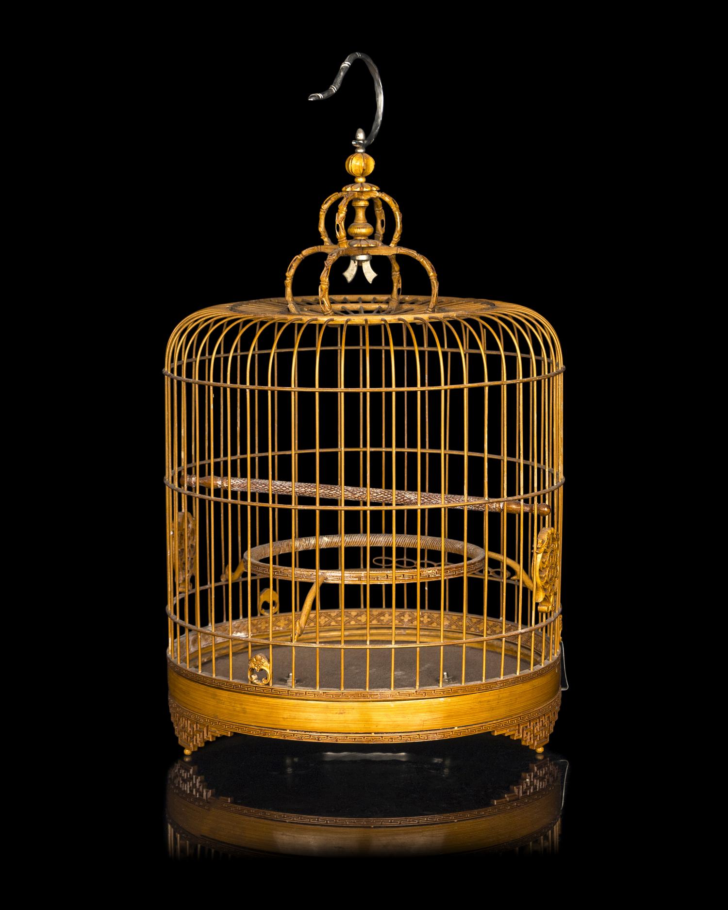 A Chinese Bamboo Bird Cage with A Pair of Wucai Porcelain Bird Feeders