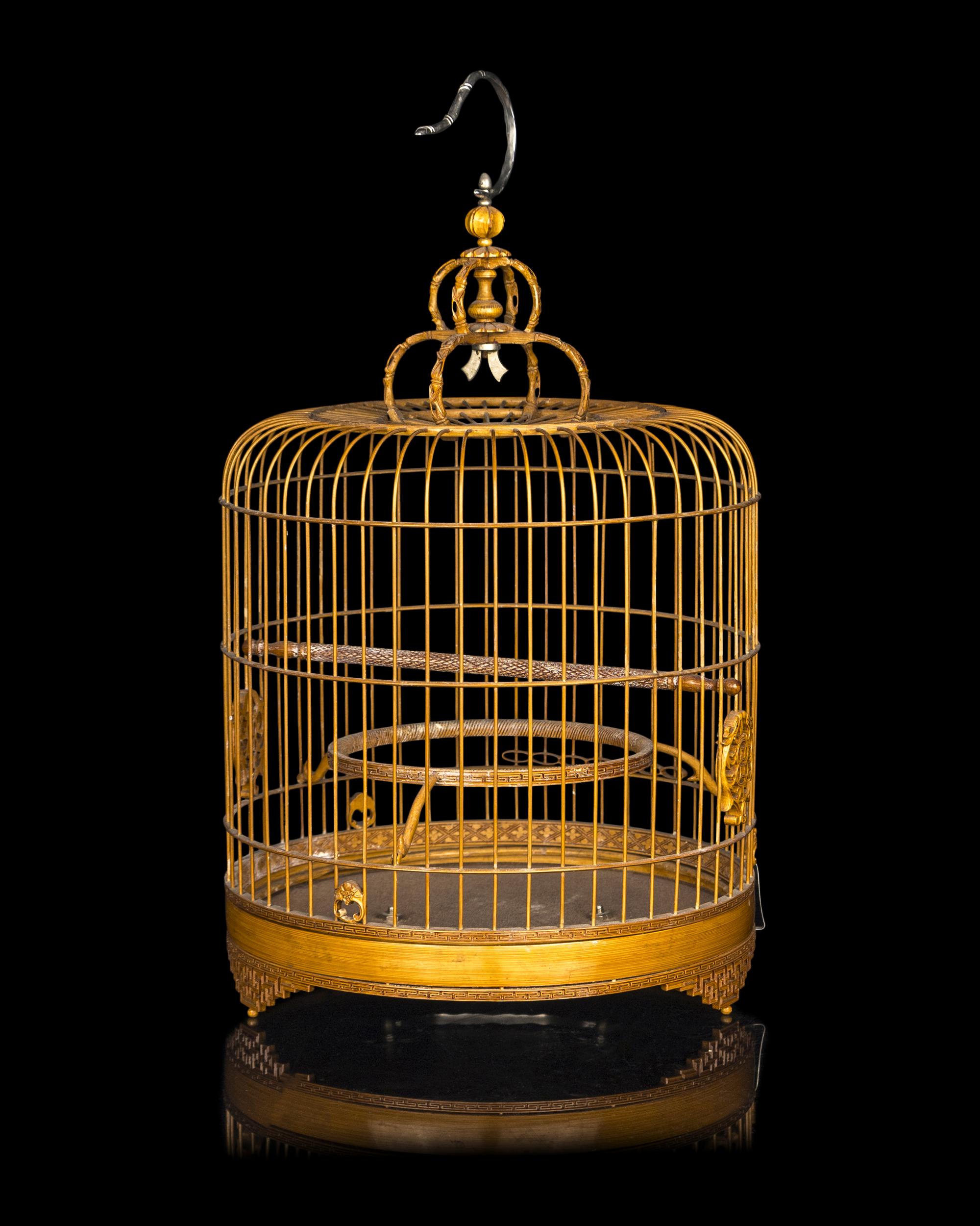 A Chinese Bamboo Bird Cage with A Pair of Wucai Porcelain Bird Feeders