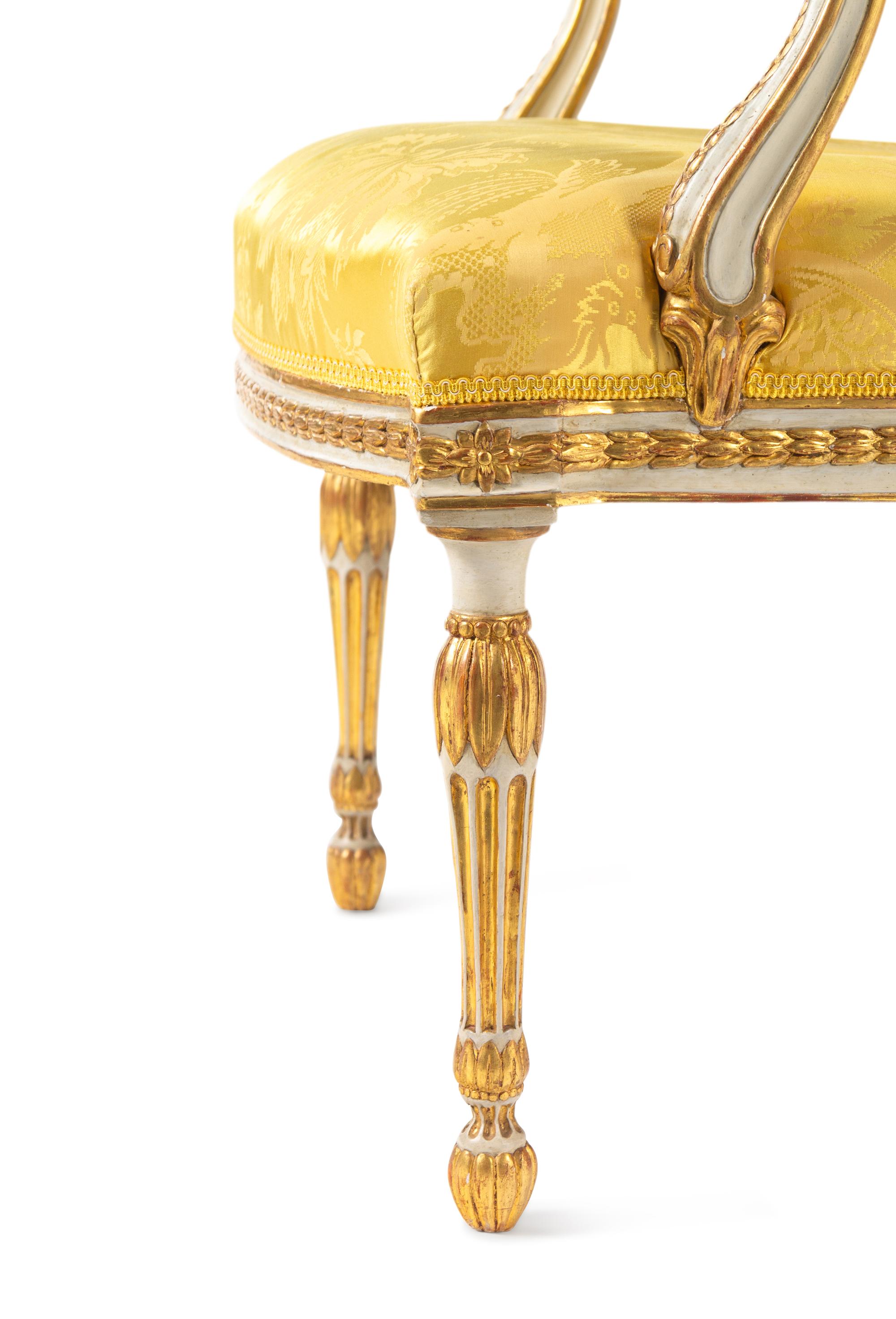 A Matched Pair of George III White-Painted and Parcel-Gilt Armchairs