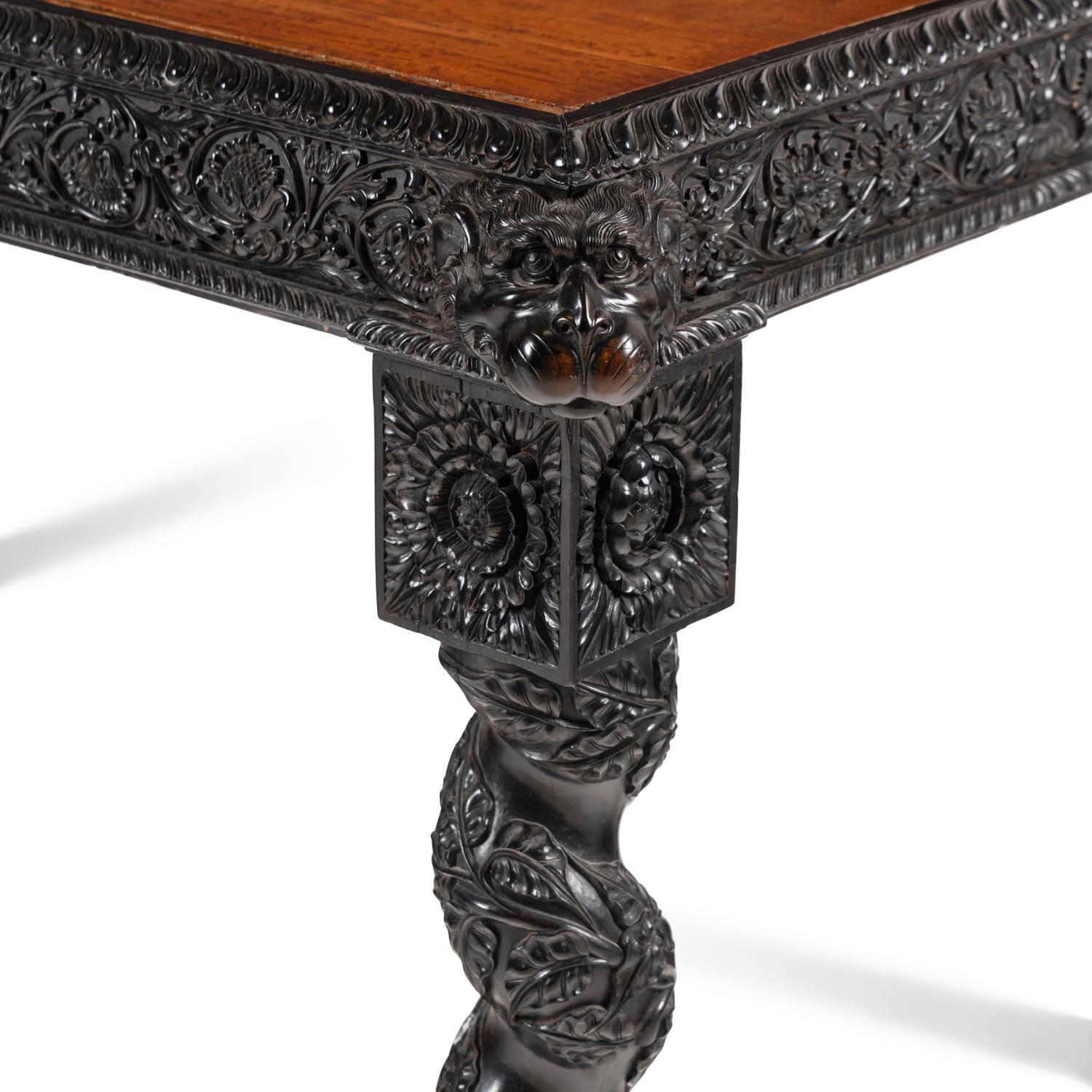 An Anglo-Colonial Carved Ebony and Satinwood Center Table