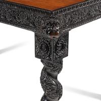 An Anglo-Colonial Carved Ebony and Satinwood Center Table