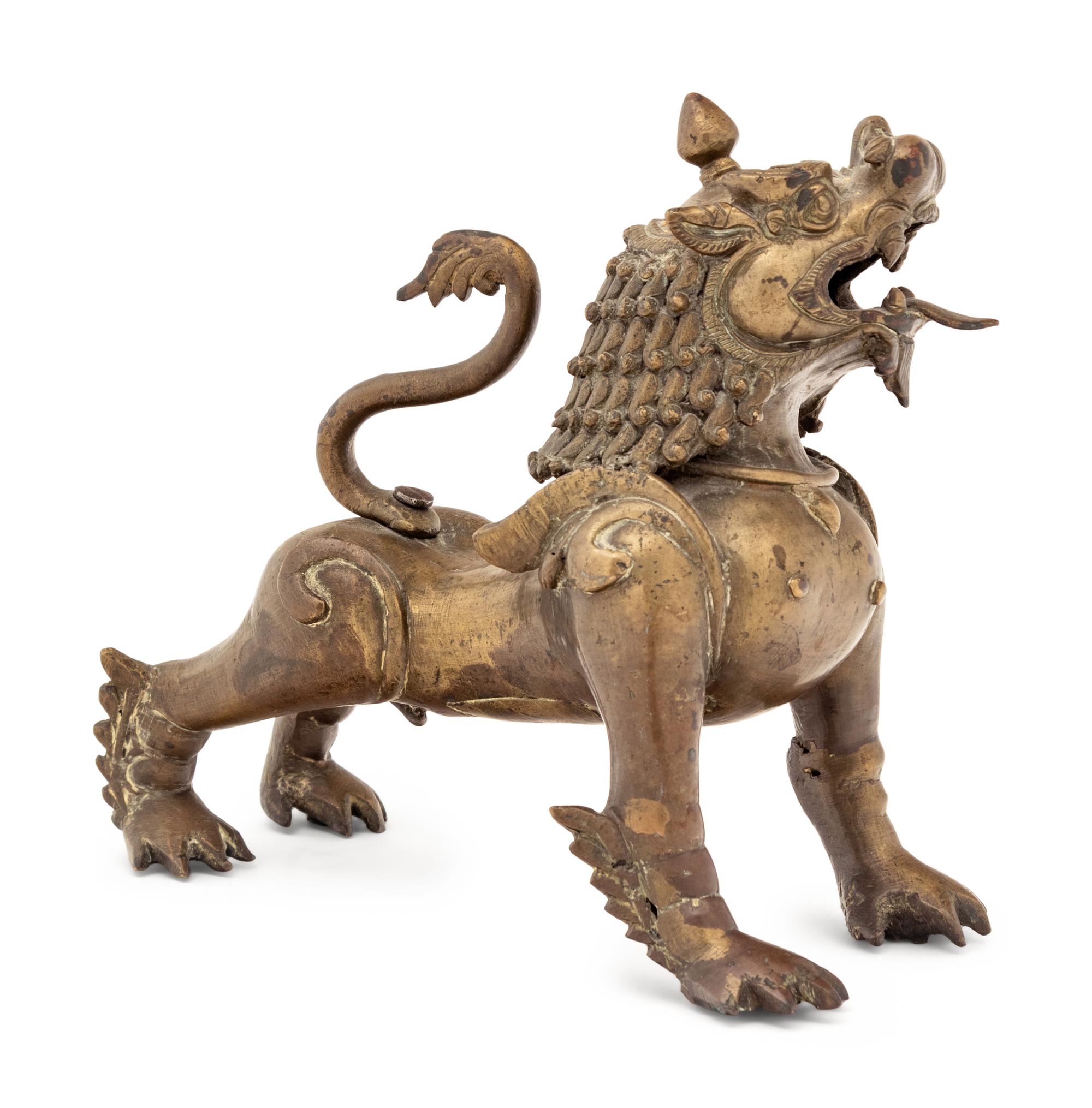 An Indian or Southeast Asian Brass Temple Lion