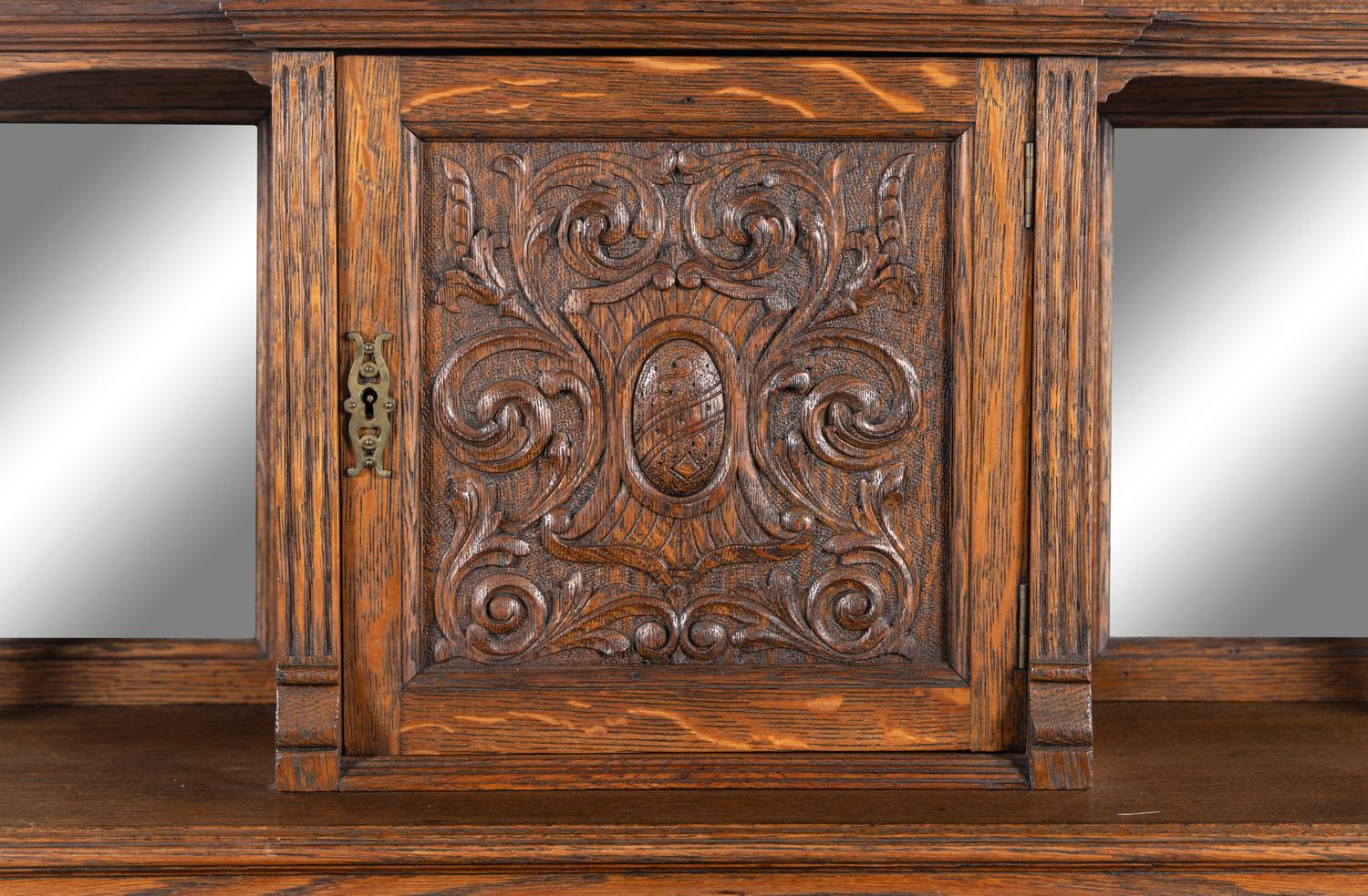 A Renaissance Revival Carved Oak Slant-Front Bureau