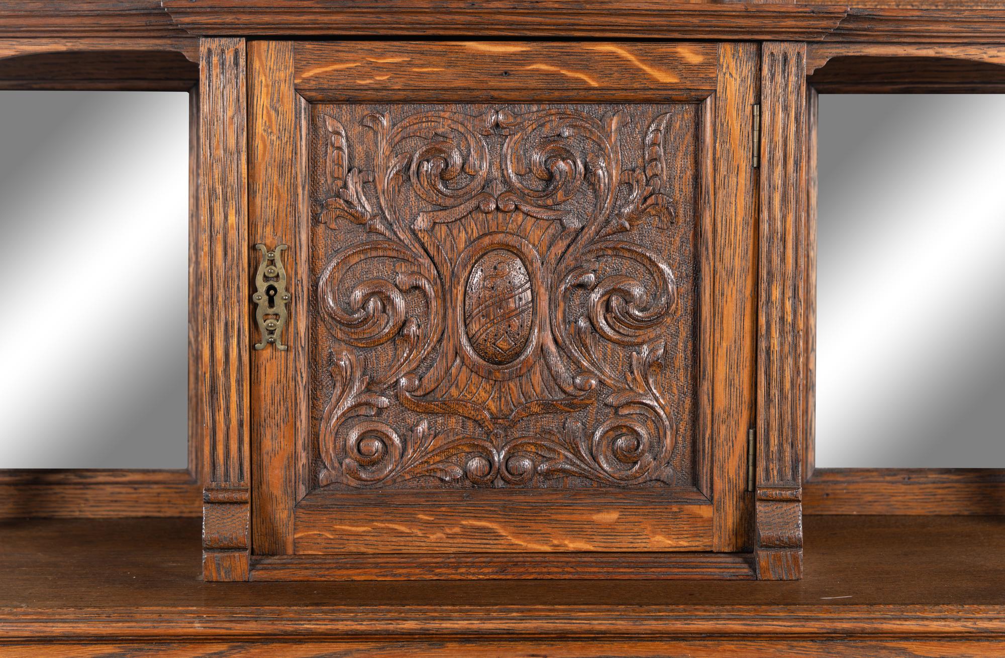 A Renaissance Revival Carved Oak Slant-Front Bureau
