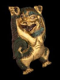A Sino-Tibetan Gilt Bronze Repoussé Fu-Lion
