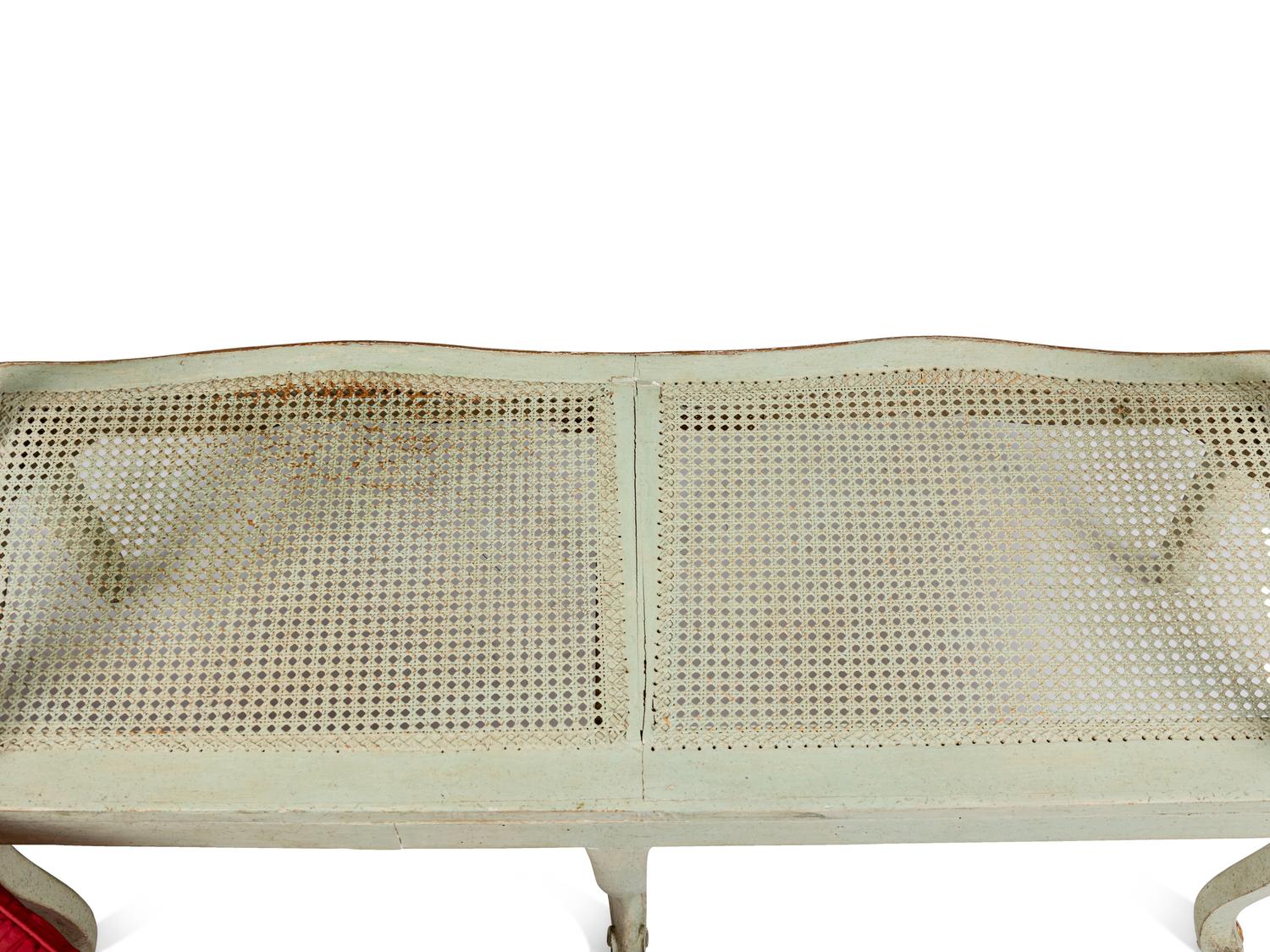 A Pair of Louis XV Green-Painted and Parcel-Gilt Cane Seat Window Benches