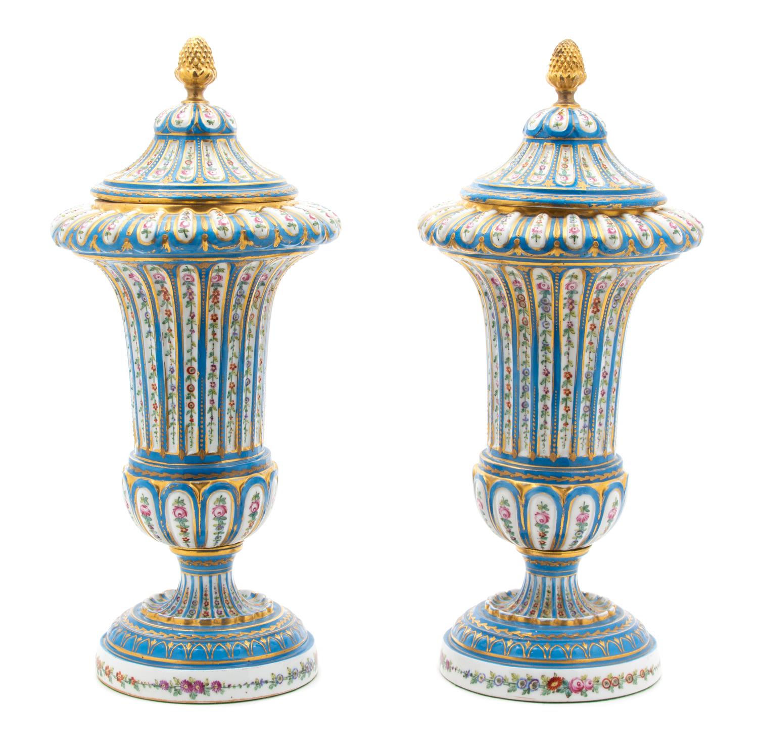 A Pair of Sevres Style Porcelain Polychrome and Gilt Decorated Covered Urns Height 14 3/4 inches — 19TH CENTURY
