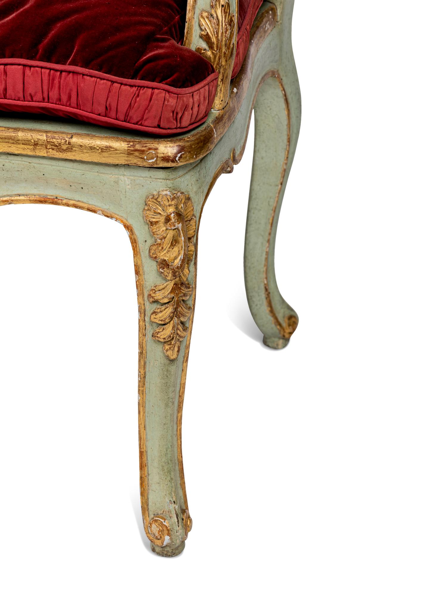 A Pair of Louis XV Green-Painted and Parcel-Gilt Cane Seat Window Benches