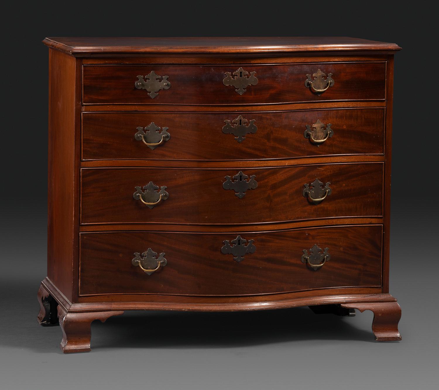 A Chippendale Figured Mahogany Serpentine Chest of Drawers