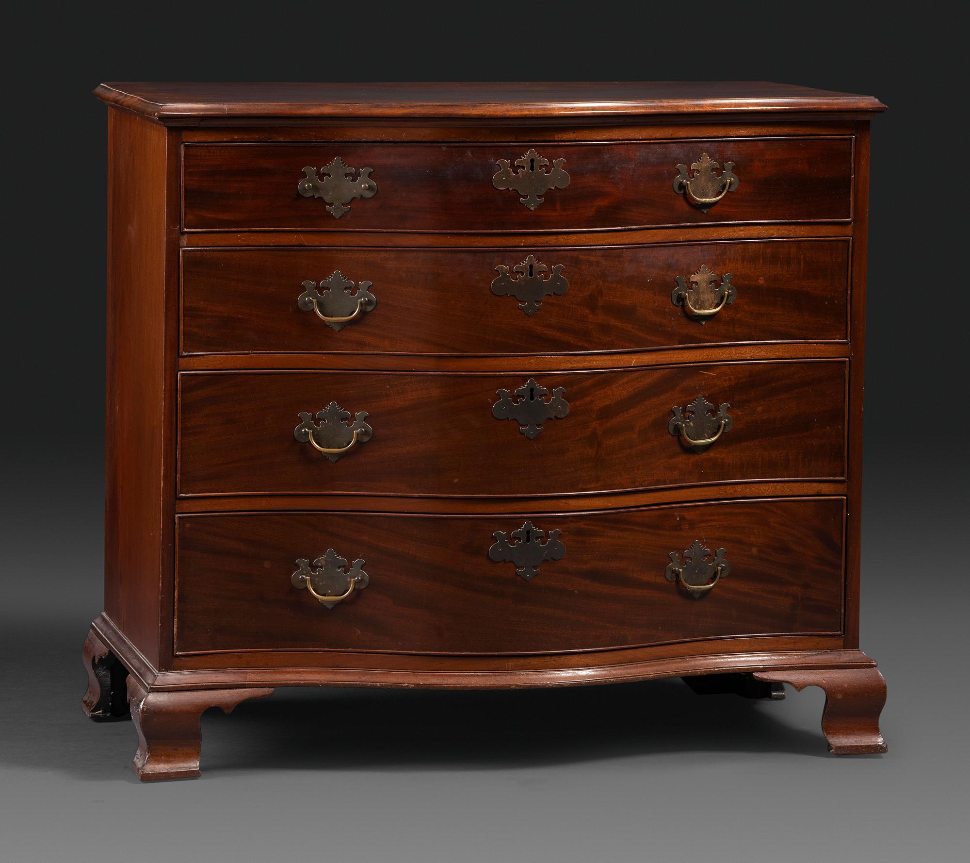 A Chippendale Figured Mahogany Serpentine Chest of Drawers