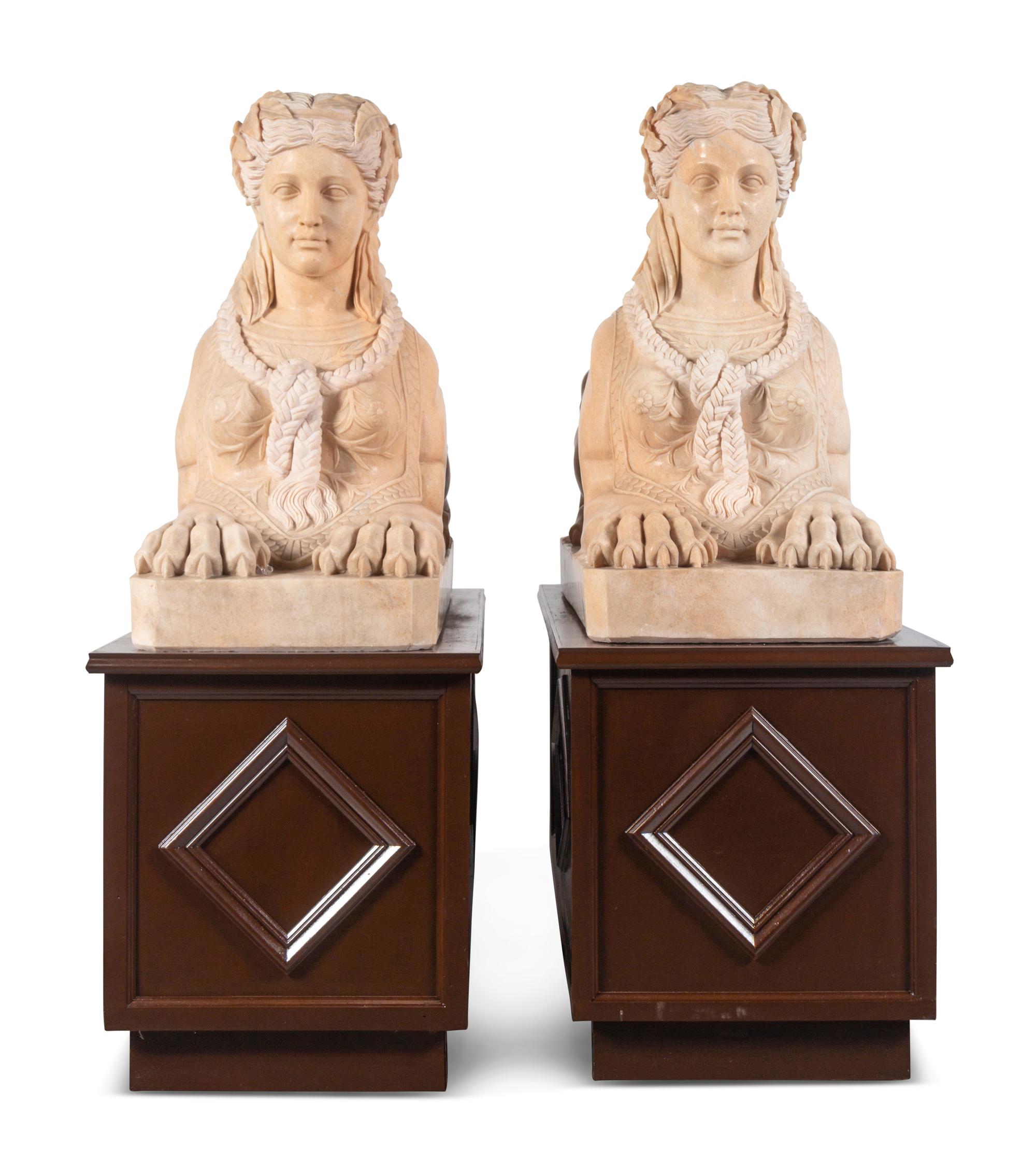A Pair of Large Composite Marble Sphinxes