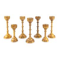 A Collection of Seven Brass Altar Candlesticks