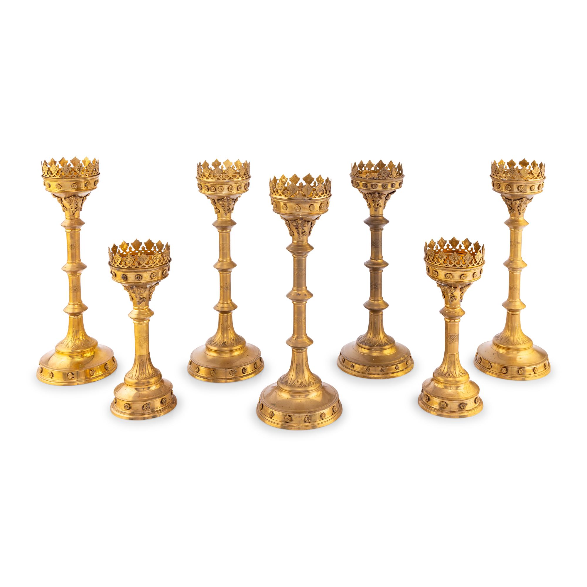 A Collection of Seven Brass Altar Candlesticks