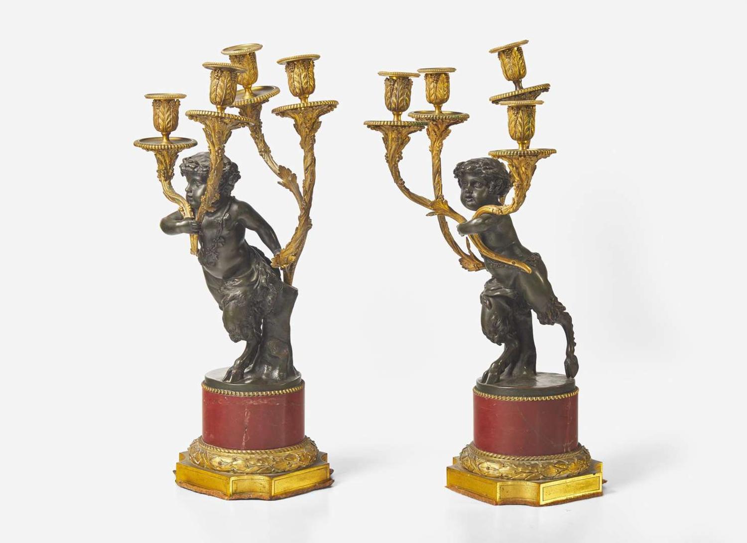 A pair of Louis XVI style gilt and patinated bronze candelabras depicting fauns, late 19th century