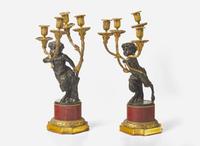 A pair of Louis XVI style gilt and patinated bronze candelabras depicting fauns, late 19th century