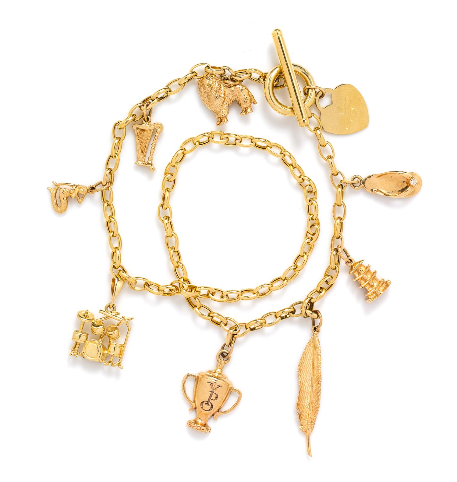 A 14 Karat Yellow Gold Charm Necklace with Nine Attached Charms, 22.00 dwts.