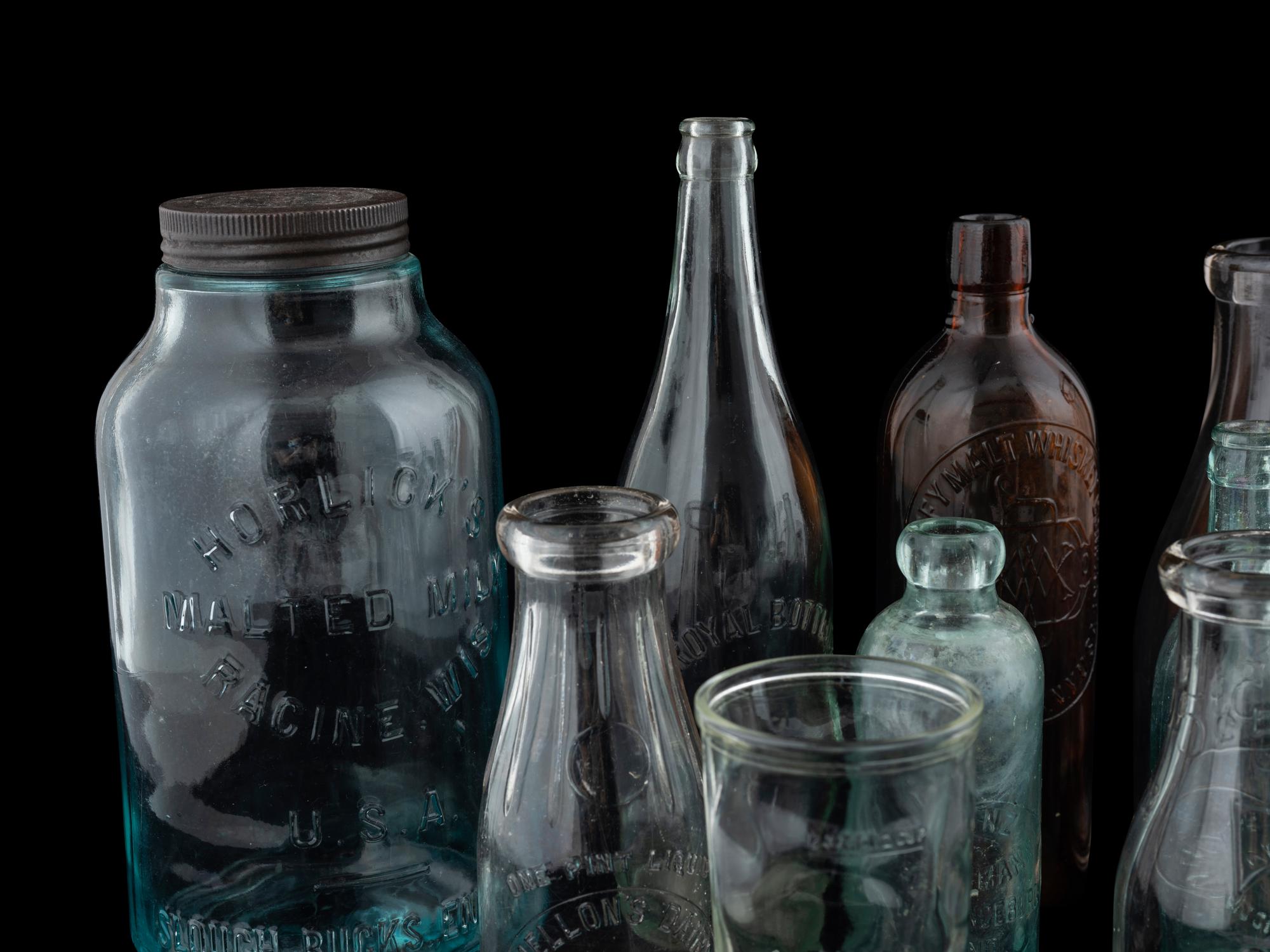 Sixteen Glass Advertising Bottles