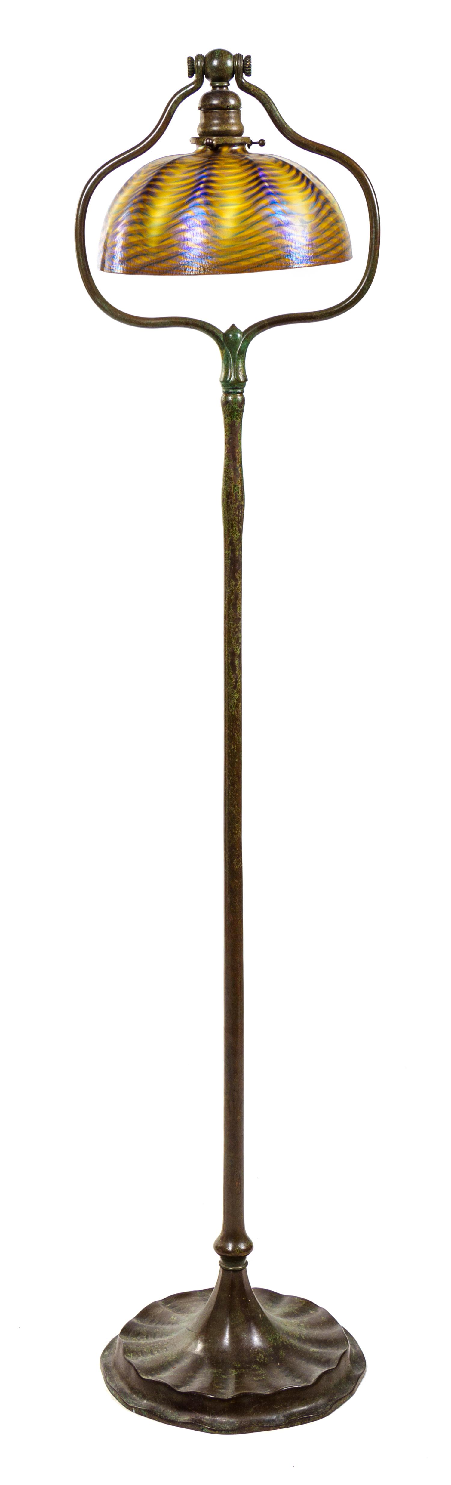A Tiffany Favrile Glass and Bronze Floor Lamp Height 55 1/2 x diameter of shade 10 inches.
